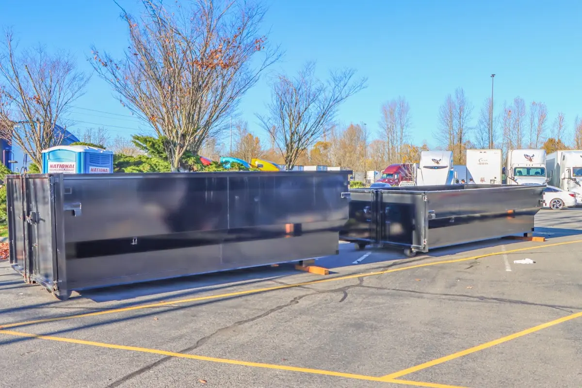 Professional dumpster rental service with roll-off container on residential driveway in Surfside